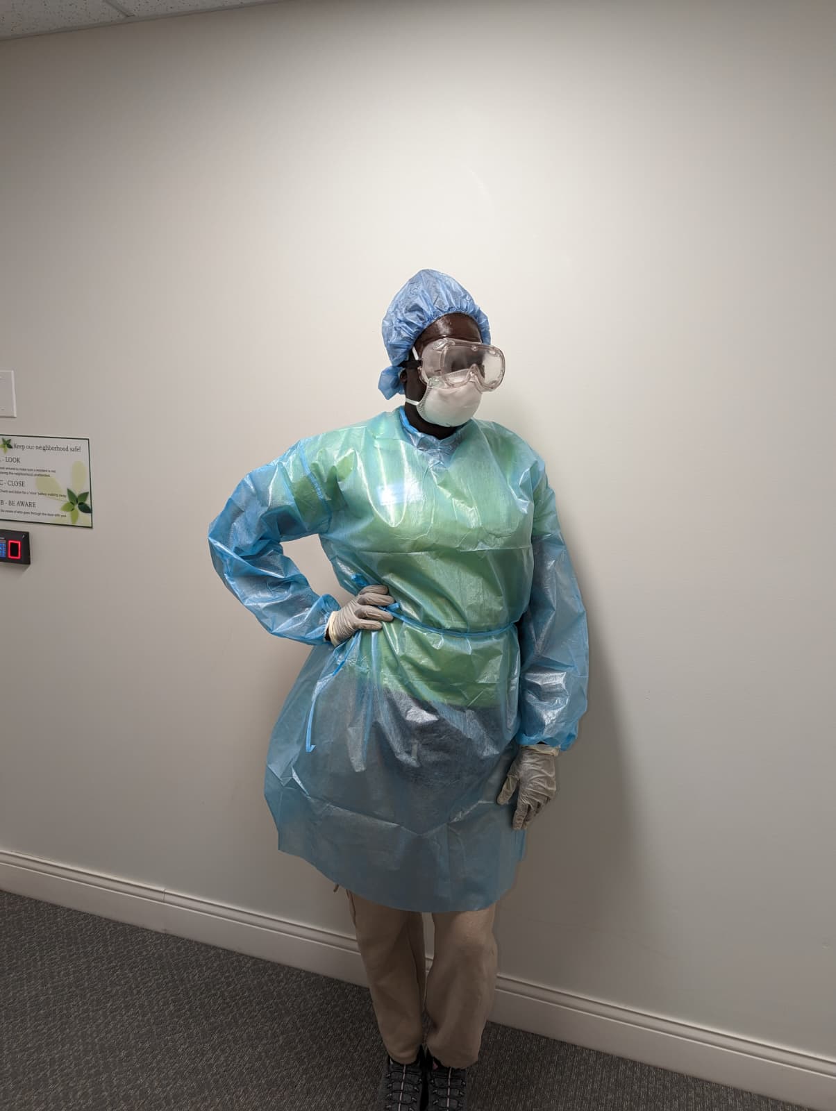 A caregiver in full PPE: gown, gloves, mask and goggles.